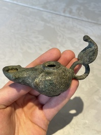 A bronze urn, a bronze canteen with relief design and a pair of bronze oil lamps, Roman Empire, 9th C. B.C/5th C.