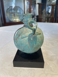 A bronze urn, a bronze canteen with relief design and a pair of bronze oil lamps, Roman Empire, 9th C. B.C/5th C.