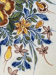 A fine polychrome Dutch Delft 'flower vase' plaque, 18th C.