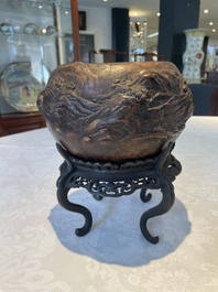 A Chinese agarwood brush washer with landscape relief design on wooden stand, 17/18th C.