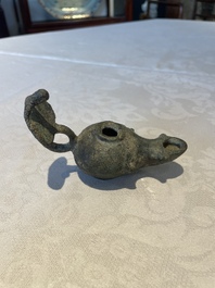 A bronze urn, a bronze canteen with relief design and a pair of bronze oil lamps, Roman Empire, 9th C. B.C/5th C.