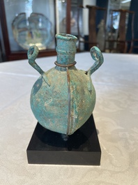 A bronze urn, a bronze canteen with relief design and a pair of bronze oil lamps, Roman Empire, 9th C. B.C/5th C.