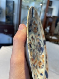 A group of thirteen Chinese blue, white and famille rose plates and a bowl, late Ming/early Qing