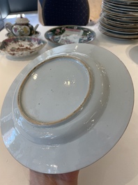 A pair of Chinese famille rose black-ground 'flowers and scrolls' plates, Yongzheng/Qianlong