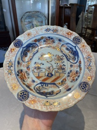 A group of thirteen Chinese blue, white and famille rose plates and a bowl, late Ming/early Qing