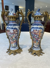 A pair of Chinese Canton famille rose 'mandarin subject' vases with gilt bronze mounts, Qianlong