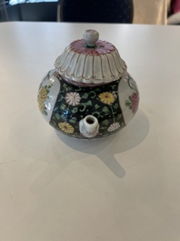 A Chinese famille rose black-ground teapot with cover and stand and a sauce boat, Qianlong