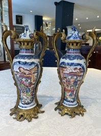A pair of Chinese Canton famille rose 'mandarin subject' vases with gilt bronze mounts, Qianlong