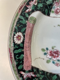 A pair of Chinese famille rose black-ground 'flowers and scrolls' plates, Yongzheng/Qianlong