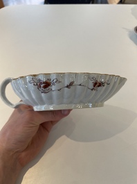A Chinese famille rose black-ground teapot with cover and stand and a sauce boat, Qianlong
