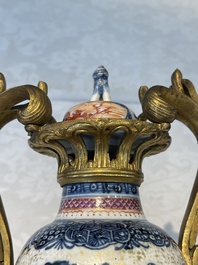 A pair of Chinese Canton famille rose 'mandarin subject' vases with gilt bronze mounts, Qianlong