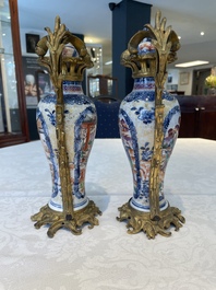 A pair of Chinese Canton famille rose 'mandarin subject' vases with gilt bronze mounts, Qianlong