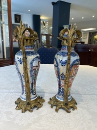 A pair of Chinese Canton famille rose 'mandarin subject' vases with gilt bronze mounts, Qianlong