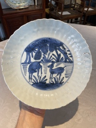 A group of thirteen Chinese blue, white and famille rose plates and a bowl, late Ming/early Qing