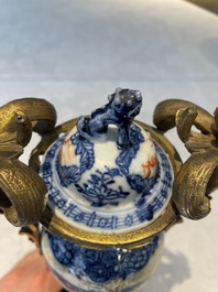 A pair of Chinese Canton famille rose 'mandarin subject' vases with gilt bronze mounts, Qianlong