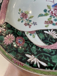 A pair of Chinese famille rose black-ground 'flowers and scrolls' plates, Yongzheng/Qianlong