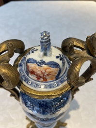 A pair of Chinese Canton famille rose 'mandarin subject' vases with gilt bronze mounts, Qianlong