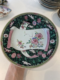 A pair of Chinese famille rose black-ground 'flowers and scrolls' plates, Yongzheng/Qianlong