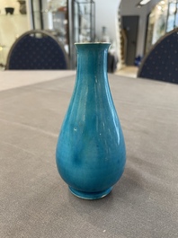 Three Chinese monochrome turquoise-glazed vases with two wooden stands, Kangxi and later