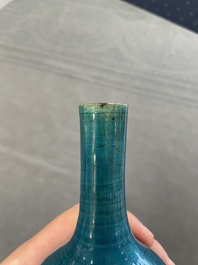 Three Chinese monochrome turquoise-glazed vases with two wooden stands, Kangxi and later