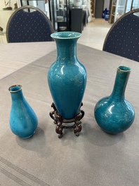 Three Chinese monochrome turquoise-glazed vases with two wooden stands, Kangxi and later