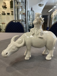 A Chinese blue and white garlic-mouth vase and a white glazed group of a boy on a buffalo, Wanli/Qianlong