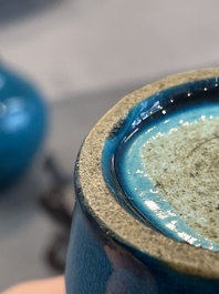 Three Chinese monochrome turquoise-glazed vases with two wooden stands, Kangxi and later