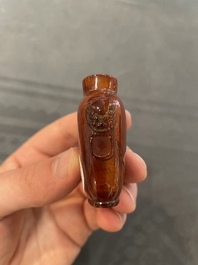 Eleven Chinese snuff bottles in amber, agate, rock crystal, lacquer, hardstone, metal and wood, 19/20th C.