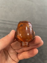 Eleven Chinese snuff bottles in amber, agate, rock crystal, lacquer, hardstone, metal and wood, 19/20th C.