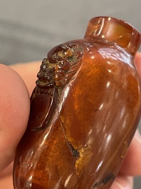 Eleven Chinese snuff bottles in amber, agate, rock crystal, lacquer, hardstone, metal and wood, 19/20th C.
