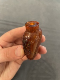 Eleven Chinese snuff bottles in amber, agate, rock crystal, lacquer, hardstone, metal and wood, 19/20th C.