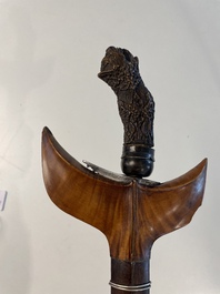 A collection of six krises with carved handles, four with scabbard, Indonesia, 19th C.