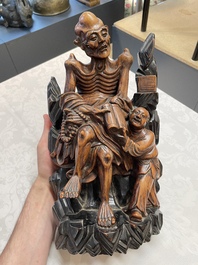 Two Chinese boxwood sculptures of Luohan and Liuhai and a bamboo sculpture of a sage, 17/19th C.