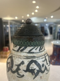 An early Islamic pottery albarello with engraved copper mount and cover, probably Nishapur, Iran, 10/11th C.