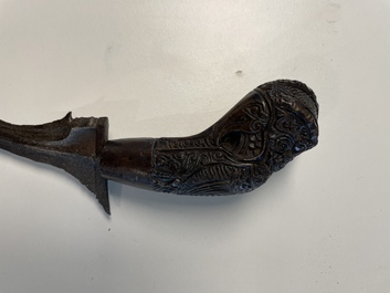 A collection of six krises with carved handles, four with scabbard, Indonesia, 19th C.