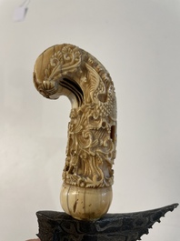 A collection of six krises with carved handles, four with scabbard, Indonesia, 19th C.