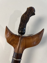 A collection of six krises with carved handles, four with scabbard, Indonesia, 19th C.