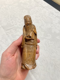 Two Chinese boxwood sculptures of Luohan and Liuhai and a bamboo sculpture of a sage, 17/19th C.