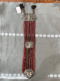 A gold lame woman's belt, a breast ornament and a silver karwat, Caucasus and Afghanistan, 19th C.