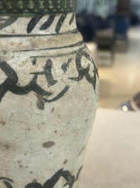 An early Islamic pottery albarello with engraved copper mount and cover, probably Nishapur, Iran, 10/11th C.