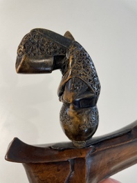 A collection of six krises with carved handles, four with scabbard, Indonesia, 19th C.