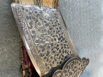 A gold lame woman's belt, a breast ornament and a silver karwat, Caucasus and Afghanistan, 19th C.
