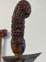 A collection of six krises with carved handles, four with scabbard, Indonesia, 19th C.