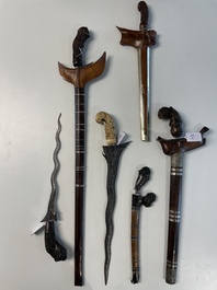 A collection of six krises with carved handles, four with scabbard, Indonesia, 19th C.