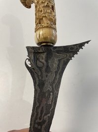 A collection of six krises with carved handles, four with scabbard, Indonesia, 19th C.