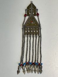 Two silver bracelets, two pendants with carnelian stones, a silver back ornament and a silver capstone, Turkmenistan, 19/20th C.