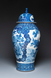 A massive Japanese blue and white Arita vase and cover with an eagle, a shishi and cub, 19th C.