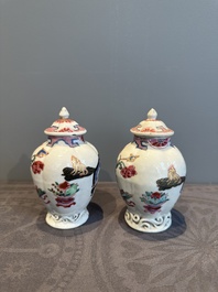 A pair of Chinese famille rose 'antiquities' tea caddies and covers, Yongzheng/Qianlong