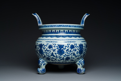 A large Chinese blue and white 'bajixiang' and 'lotus scrolls' tripod censer, Qianlong