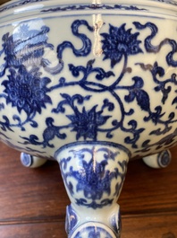 A large Chinese blue and white 'bajixiang' and 'lotus scrolls' tripod censer, Qianlong